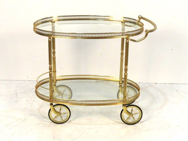 MID CENTURY OVAL GLASS & BRASS BAR CART: Brass with glass trays. 26 1/2"h. x 23"w. x 18"d.