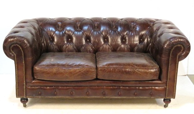 TUFTED BROWN LEATHER CHESTERFIELD 2 CUSHION SOFA: Distressed brown leather. 31"h. x 71"w. x 37"d.