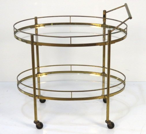 MID CENTURY OVAL BRASS BAR CART: Brass and glass shelves. 31 1/2"h. x 31"w. x 20"d.
