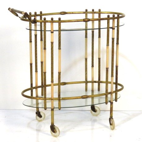MID CENTURY MODERN OVAL BAR CART: Brass with cream painted metal inserts. 35"h. x 31 1/2"w. x 17 1/2"d.