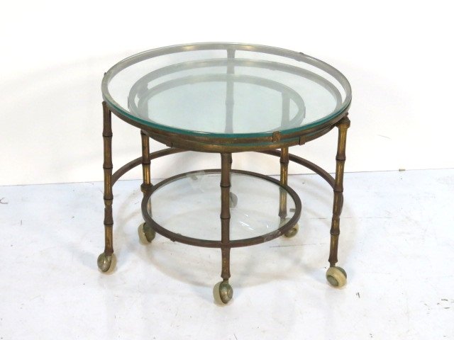 MODERN BRASS & GLASS PIVOTING NESTING TABLES: Brass table with swing out tables. Glass tops. 18"h. x 22"diam.