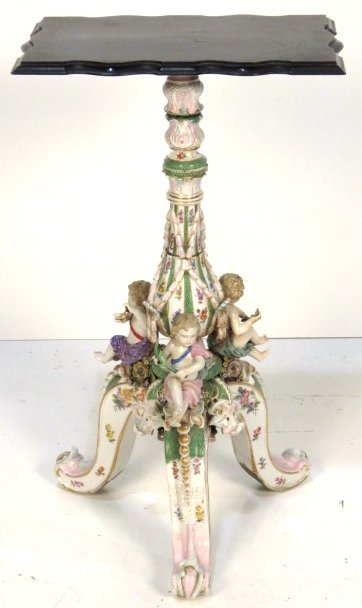 ANTIQUE FIGURAL GERMAN PORCELAIN PEDESTAL TABLE w/: Hand painted German porcelain. Ebonized wood top. 30 1/2"h. x 18"sq.