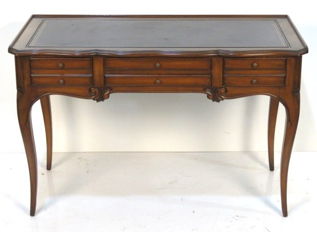 JOHN STUART FRENCH STYLE WALNUT LEATHERTOP DESK: Black leather top with gold tooling. 31 1/4"h. x 48 1/4"w. x 23 3/4"d.