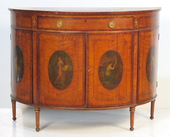 ANTIQUE ADAMS STYLE PAINT DECORATED DEMILUNE COMMODE: Paint decoration with images of woman. Satinwood with inlay and rosewood banding. 38"h. x 50 1/4"w. x 21"d.