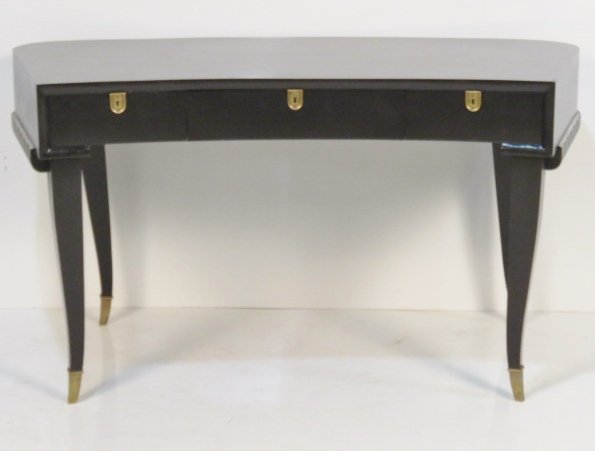 ART DECO STYLE EBONIZED DESK: Ebonized with bronze escutcheons and feet. 30"h. x 55"w. x 28"d.
