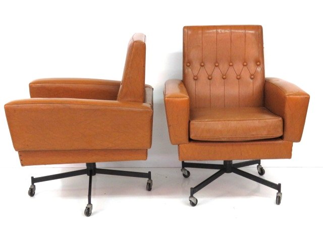Pair ITALIAN MODERN SWIVEL LOUNGE CHAIRS: Brown vinyl with iron pedestals. 38 1/2"h. x 30"w. x 31 1/2"d.
