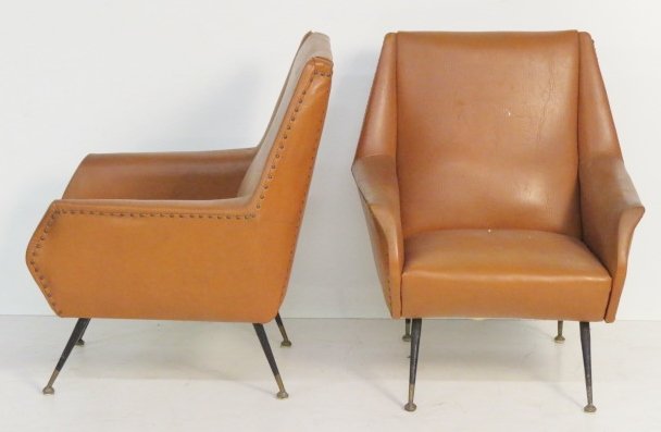 Pair ITALIAN METAL LEG LOUNGE CHAIRS: Metal legs. Brown naugahyde with nail head trim. 34"h. x 28 1/2"w. x 30"d.
