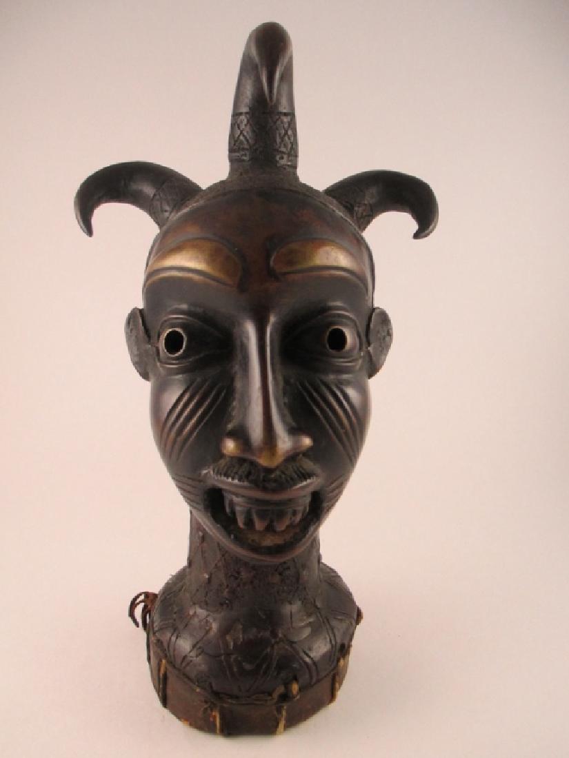 Yoruba People, Nigeria/Benin: The bronze bust depicting Eshu (Esu) with leather wrapped base. Size: 12 1/2" height.