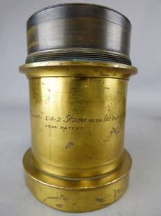 Antique Ross Carl Zeiss Planar Lens: An antique Zeiss/Ross Planar 1,4-2/300mm (12 in.) lens, Zeiss Patent No. 7715; licensed by Carl Zeiss, Jena, and manufactured by Ross, London; lens on board. Size: 3 3/4" dia. x 5" H (lens); 9" L x 9"