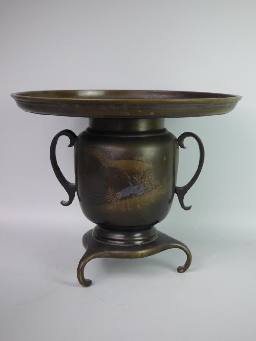 Japanese Mixed-Metals Usubata: Mixed metals; having silver inlay depicting a pair of cranes beneath moonlit sky. Size: 10 1/2" H x 13" dia.