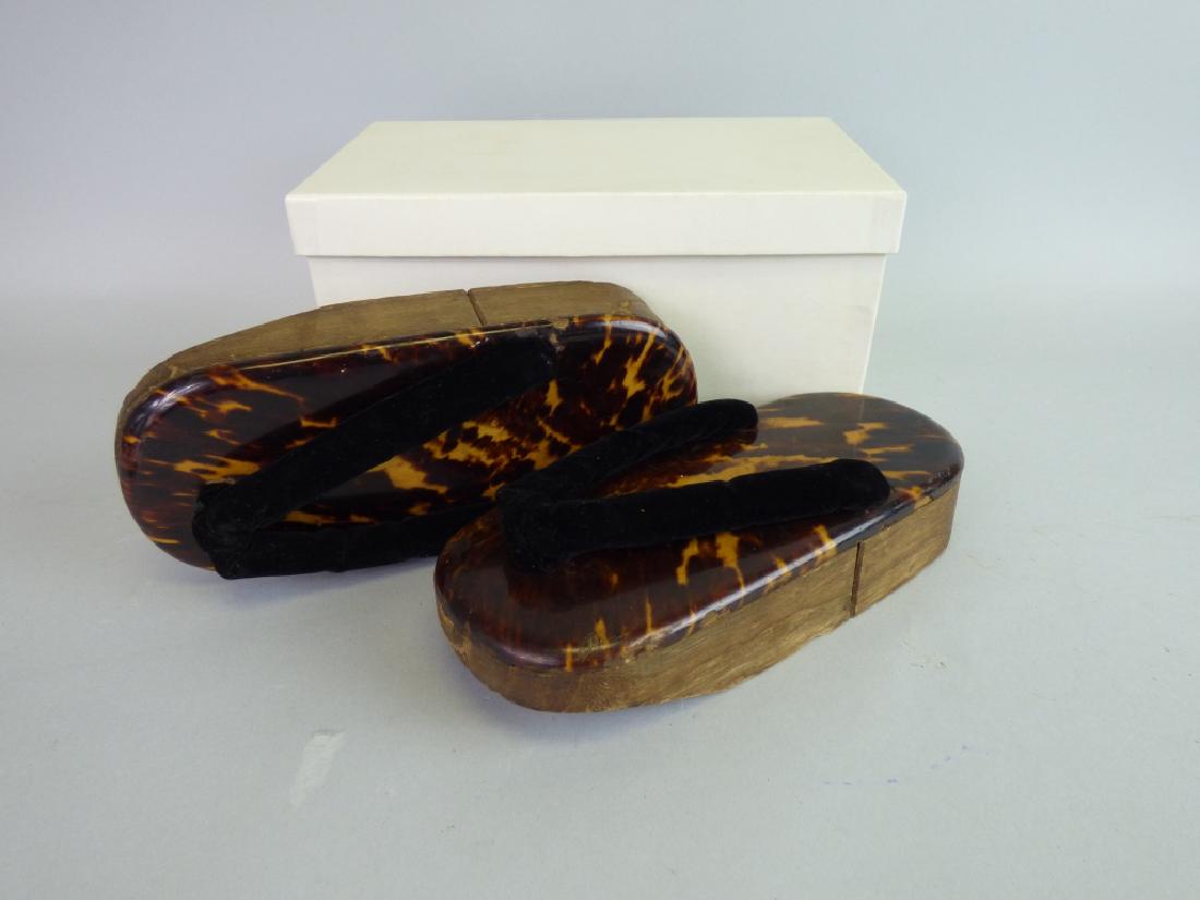 Fine Pair of Tortoiseshell-Mounted Geta Sandals: Each with mark at rear upper. Size (each): 1 5/8" H x 8 1/2" L x 3 1/4" W