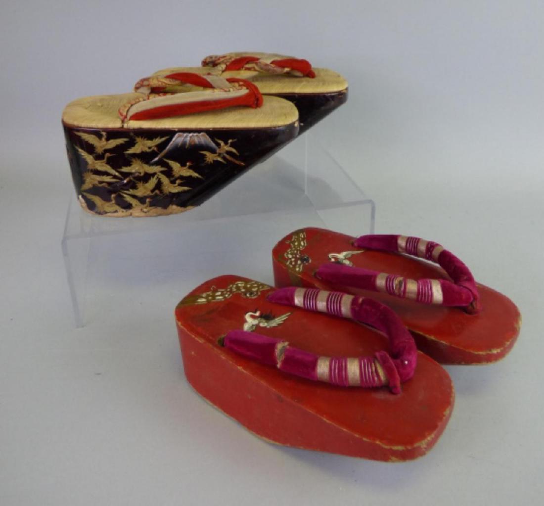 Two Pairs Lacquered Wood Geisha Sandals: Each depicting flying cranes; one red and one brown lacquer example Size (largest): 3 1/2" H x 8" L x 4" W