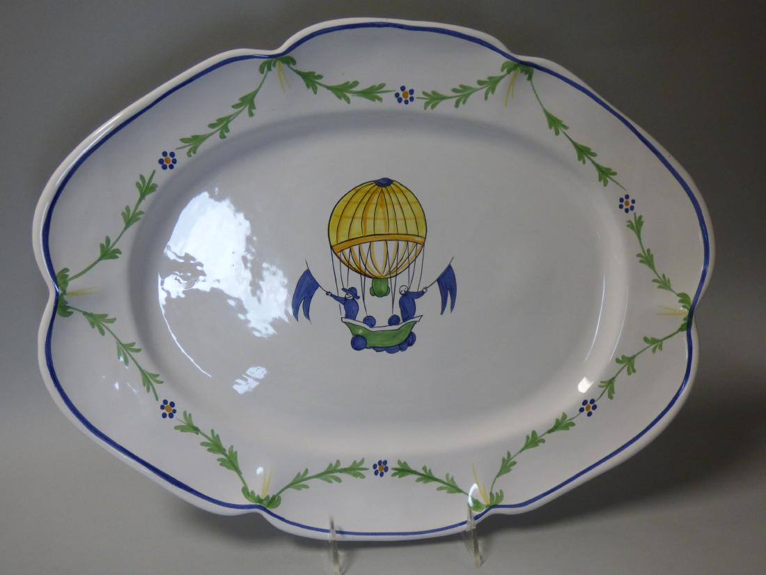 Faience Serving Platter: hot air balloon motif, the base signed indistinctly. Size: 17 1/2" dia. x 13 1/2" W