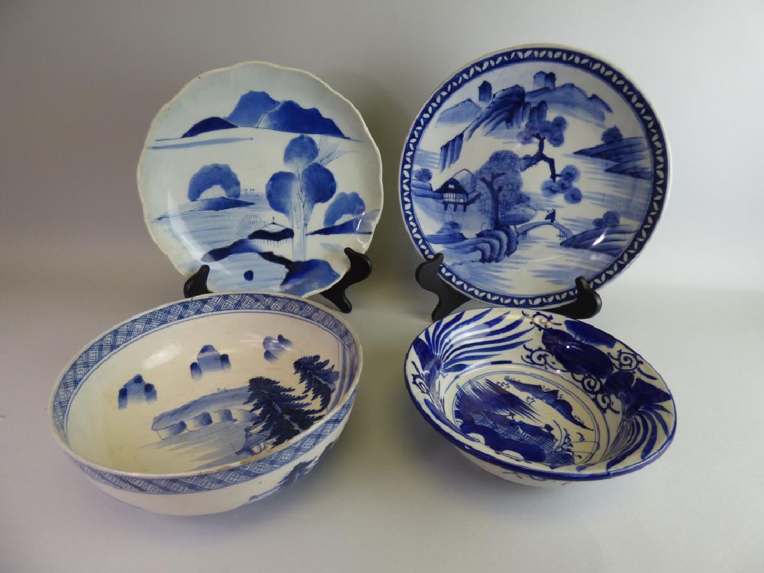 Four Japanese Blue & White Porcelain Dishes: Size (largest): 1 1/2" H x 12" dia. CONDITION REPORT: The lobed bowl with loss to one edge; one bowl with star-form hairline to base; smaller bowl repair to rim beneath