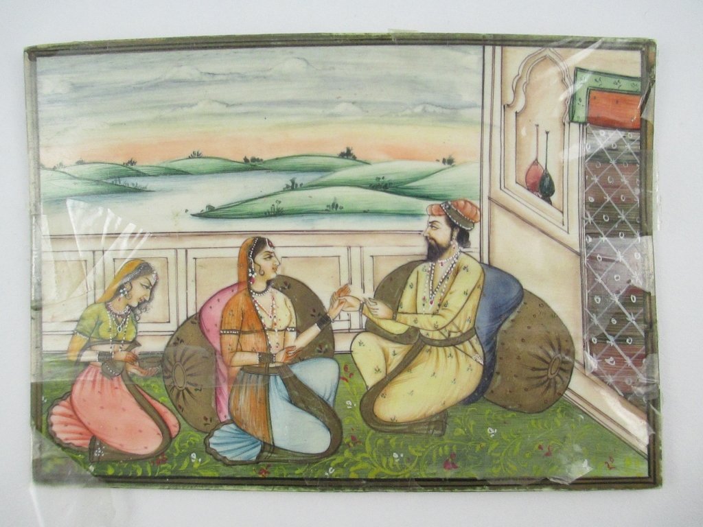 An Indian Mughal-Style Polychromed Ivory Plaque: An Islamic polychromed ivory plaque, in the Mughal style, depicting three figures in a courtyard setting. Size: 5 1/2" length x 3 3/4" width INTERNATIONAL CLIENTS ARE INELIGIBLE TO BID ON THIS ITEM. T