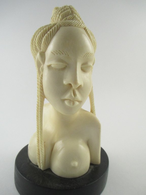 A Carved African Ivory Bust, Depicting a Lady: A carved African ivory bust, depicting a partially nude lady. Size: 8" height INTERNATIONAL CLIENTS ARE INELIGIBLE TO BID ON THIS ITEM. THIS ITEM IS FOR SALE ONLY WITHIN THE UNITED STATES, EXCEPT TO T