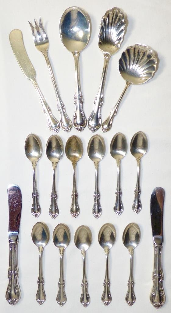 Eighteen Pieces International Sterling Tableware: In the "Joan of Arc" pattern, the group comprising one tomato spoon, one berry spoon, one table spoon, one butter knife, one lemon or cocktail fork, eleven tea spoons, and two hollowware butter knives