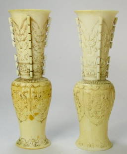 A Pair of Chinese Carved Ivory Vases: A pair of finely carved Chinese ivory vases in the archaic taste, the body of each decorated with traditional Tao-ti motif. Size: 6 1/4" H BIDDERS, PLEASE NOTE: INTERNATIONAL BIDDERS ARE INELIGIBLE TO