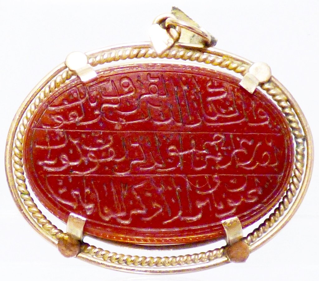 Islamic Rose Gold & Carved Carnelian Pendant: An oval Islamic inscribed carnelian intaglio pendant. Approximate weight overall g. Size: 1 1/4" L x 1 3/8" W