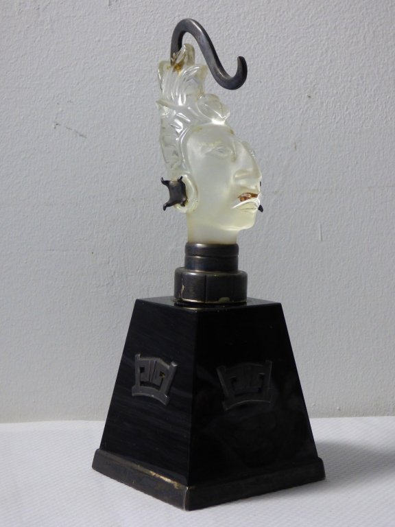 A Taxco Silver and Glass Figural Bust: Depicting the bust of a Mayan or Aztec warrior, silver-mounted frosted glass on onyx glass base, apparently unmarked. Size: 3 1/8" L x 3 1/8" W x 8 1/4" H