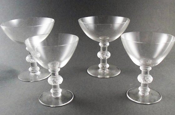 Four Lalique St. Hubert Crystal Stems: Each signed Lalique, France to base. Size: 4 1/2" height x 4 1/4" diameter (largest)