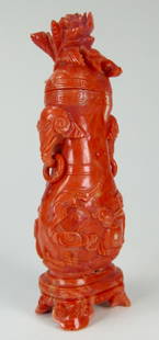 A Chinese red coral covered vase: A Chinese red coral covered vase, body decorated with a beast underneath a prunus tree, with elephant handles with loose rings on both side. Height: Approxmiate 4.25" total weight 116.8 g.