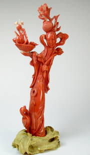 A tall Chinese red coral carving: A large Chinese red coral carving depicting a female deity carrying a flowering basket, height on base, approximate 8" overall. net coral weight without the stand 169.4g