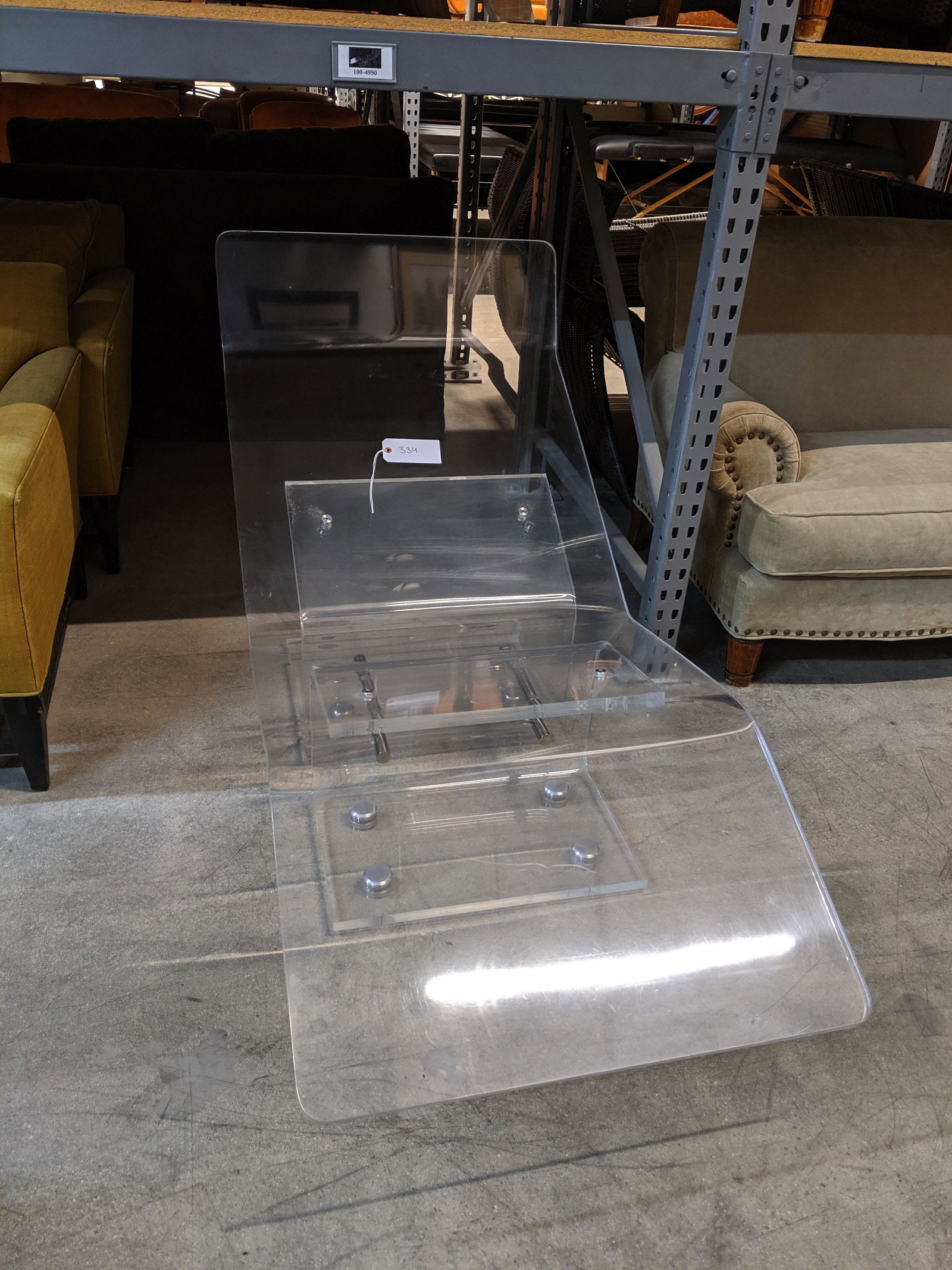 Acrylic Chaise: Acrylic chaise with stainless steel fittings.