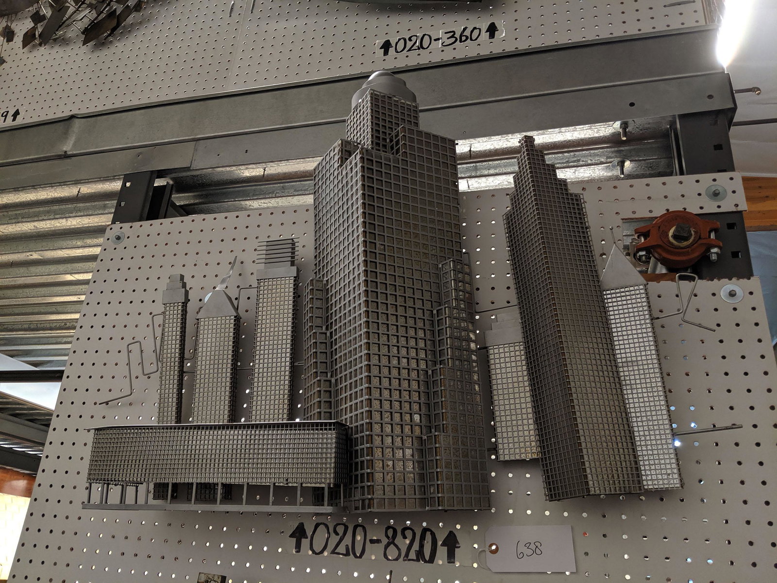 Cityscape Wall Sculpture: Aluminum cityscape wall sculpture.