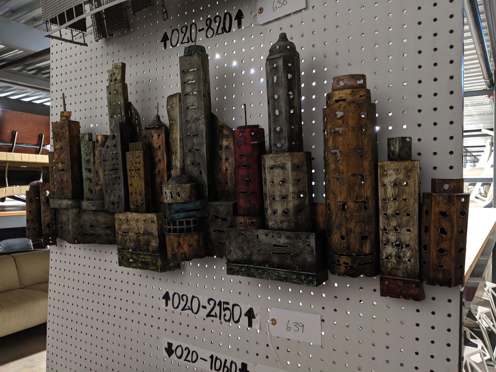 Wall Sculpture: Metal cityscape wall sculpture.