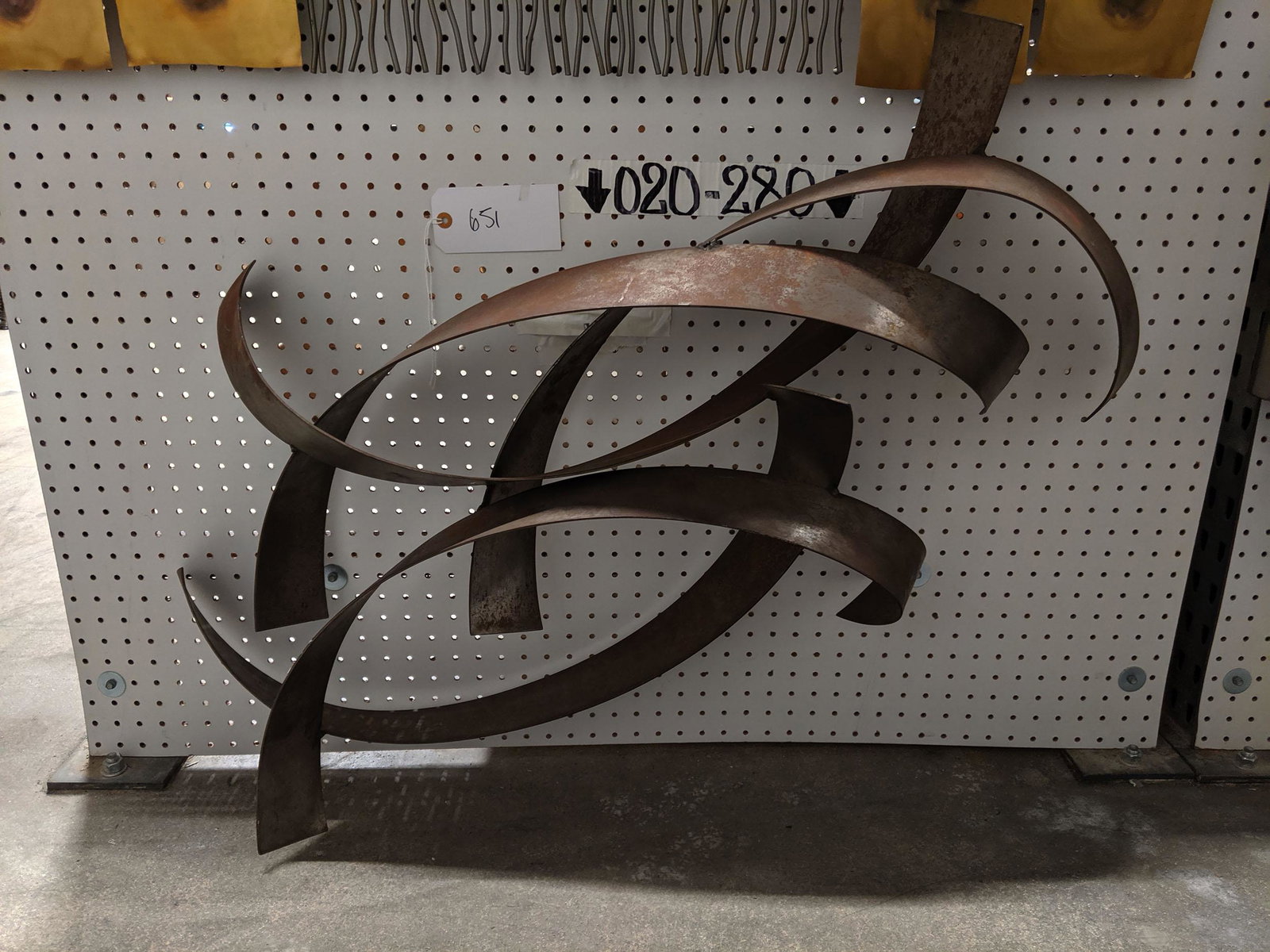 Ribbon Wall Sculpture: Metal ribbon wall sculpture.