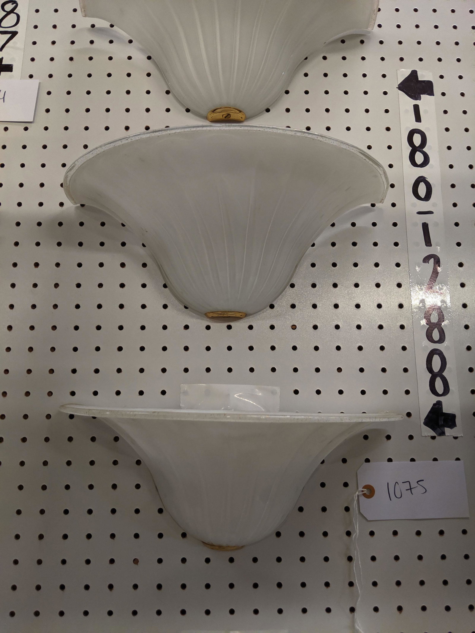 Glass Wall Sconces: Seven opaque wall sconces with flecked gold rim. Signed.