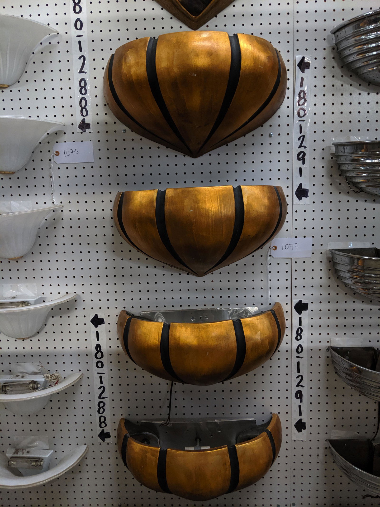 Gold Wall Sconces: Set of four gold and black wall sconces.