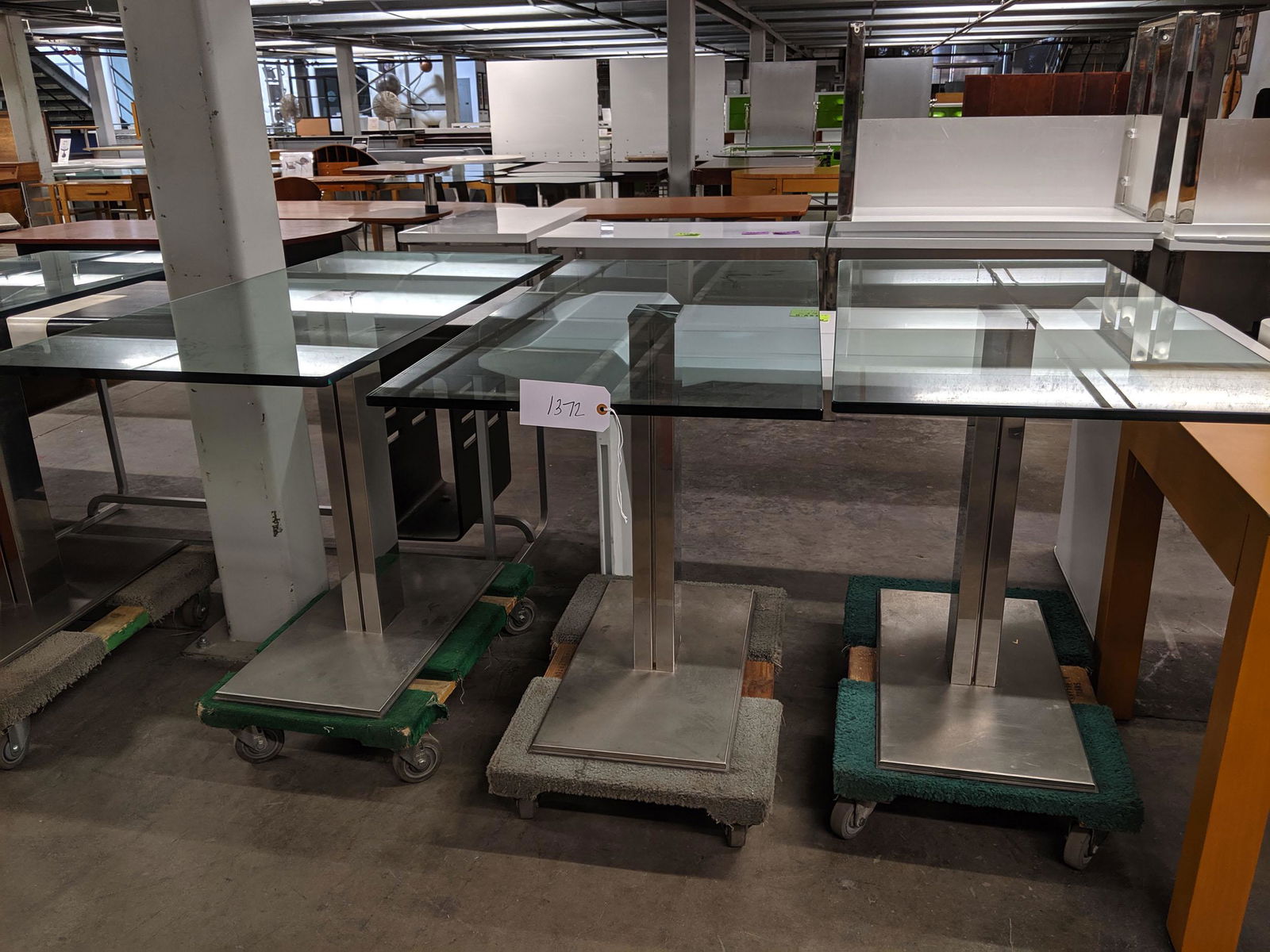 Console Tables: Set of four modern console tables with glass tops.