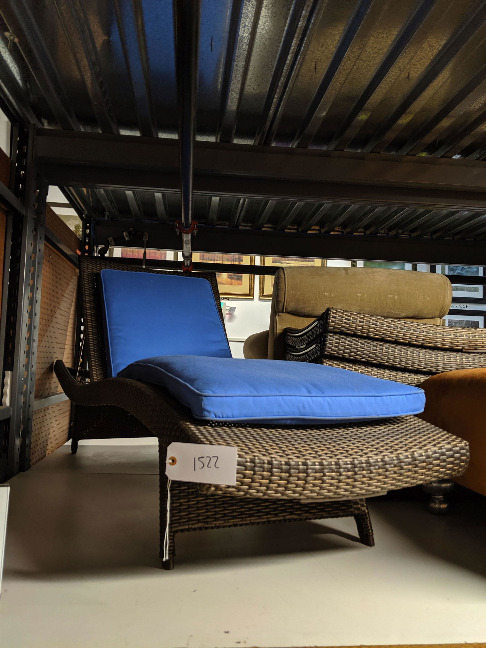 Woven Outdoor Recliners: Set of eight woven outdoor recliners with blue cushions.