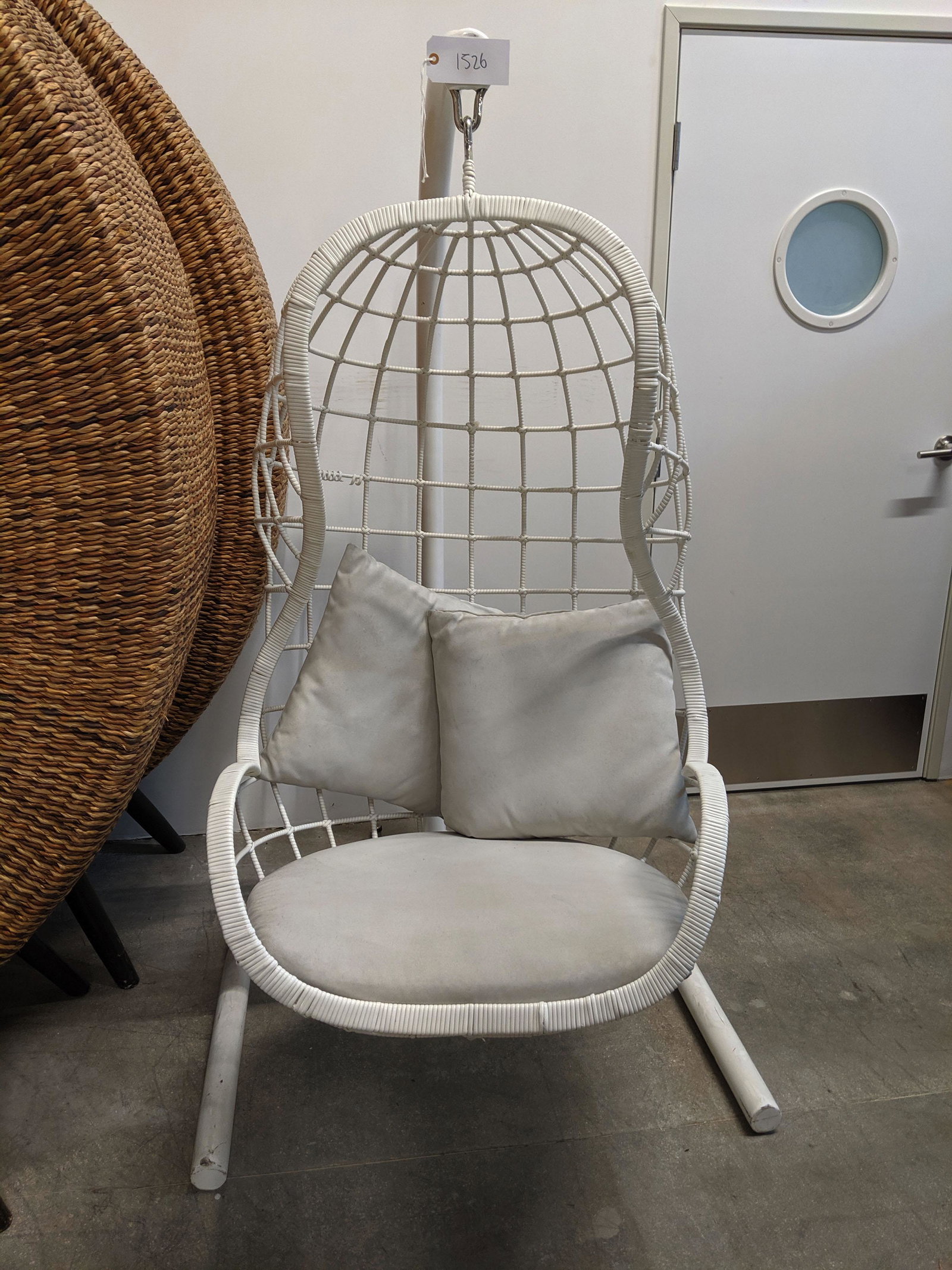 Hanging Chair: White free-standing hanging chair.