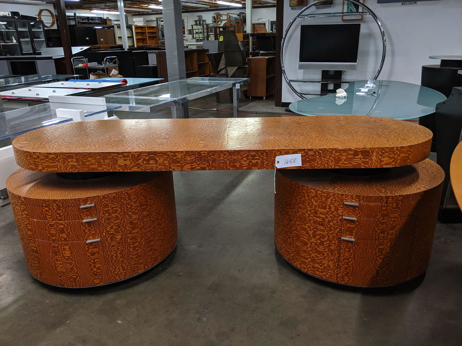 Chipped-Wood Executive Desk: Rounded executive desk with chipped-wood finish.