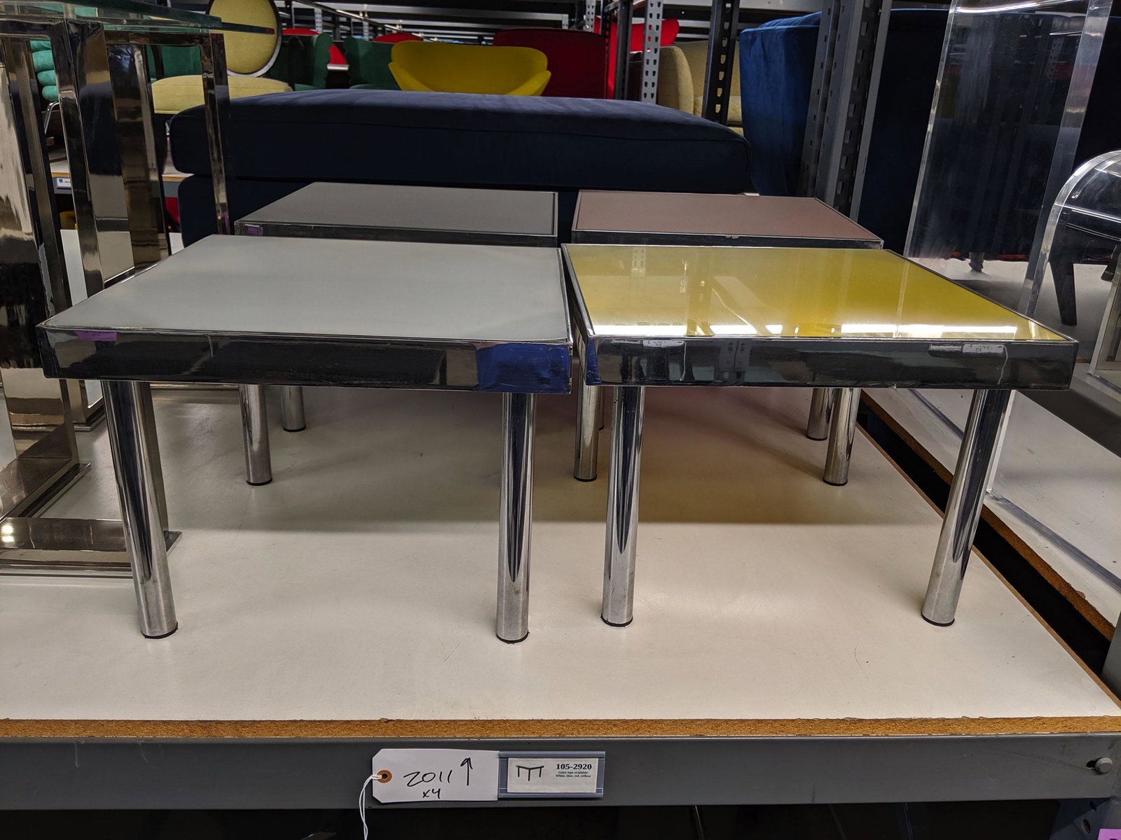 Steel Side Tables: Set of four steel side tables with colored tops.