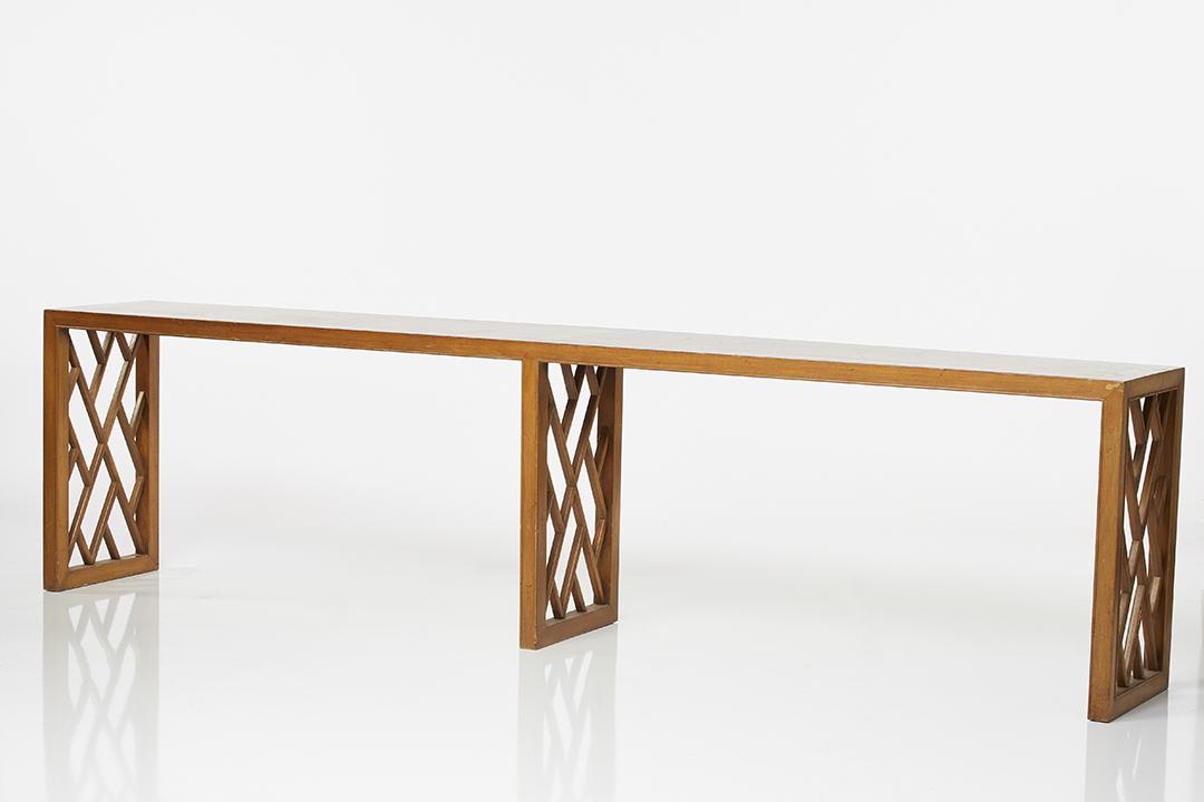 Long Walnut Console: Long walnut console table with latticed panel legs, 1960s.