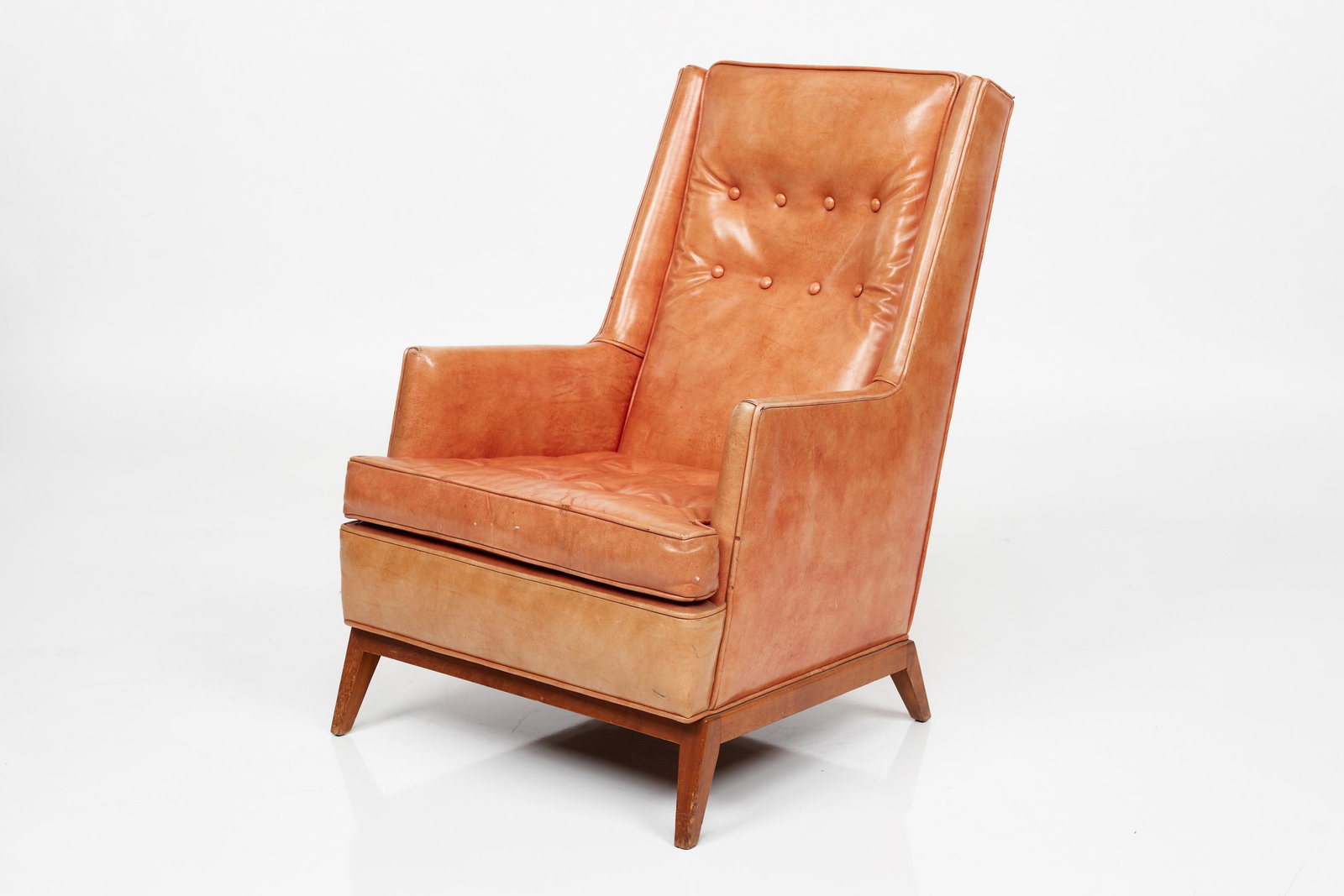 T. H. Robsjohn-Gibbings, High-Back Lounge Chair: T. H. Robsjohn-Gibbings High-backed lounge chair, 1950s Leather, mahogany. Manufactured by Widdicomb, USA. Underside with metal Grand Rapids Cabinet Maker tag and tag 'shadow' under seat cushion. 37.5