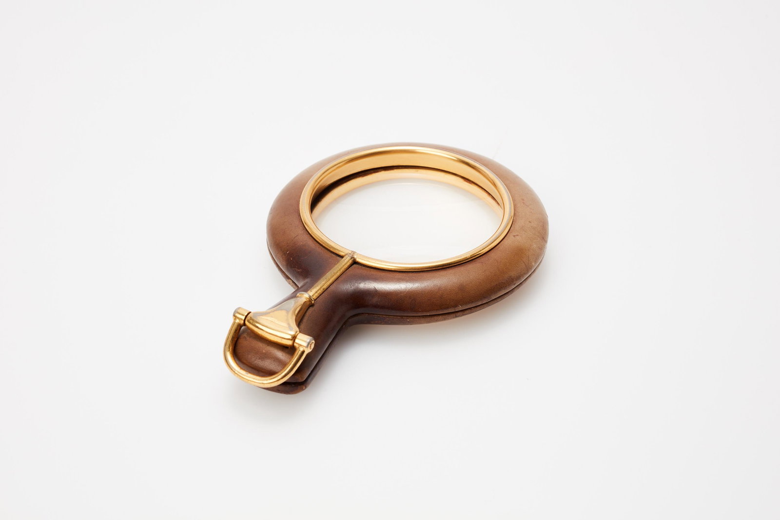 Gucci, Magnifying Glass: Gucci Magnifying glass, 1970s Leather, glass, brass. Manufactured by Gucci, Italy. Handle stamped with manufacturer's mark. 7" H x 5" W x 0.75" D