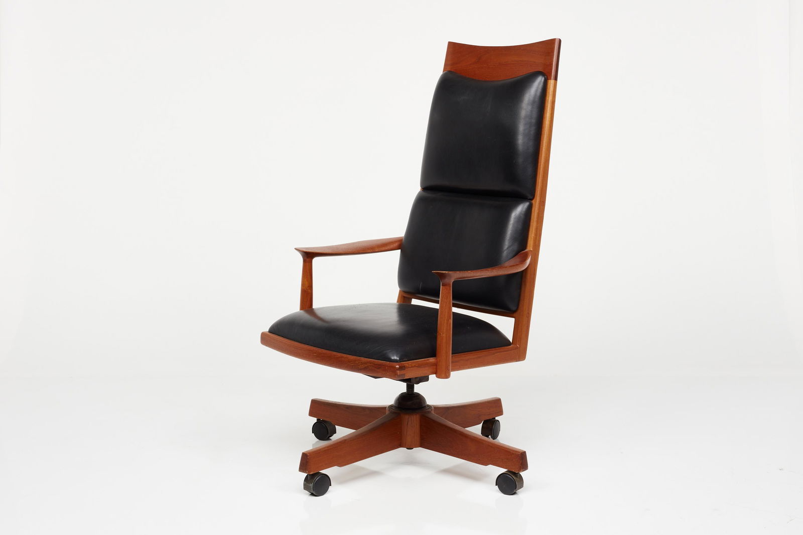 John Nyquist, High-Back Executive Chair: John Nyquist High-back executive chair, 1980s Walnut, leather. Made in the USA. Artist's carved initials to the left-facing seat edge. 50" H x 27.5" W x 27" D