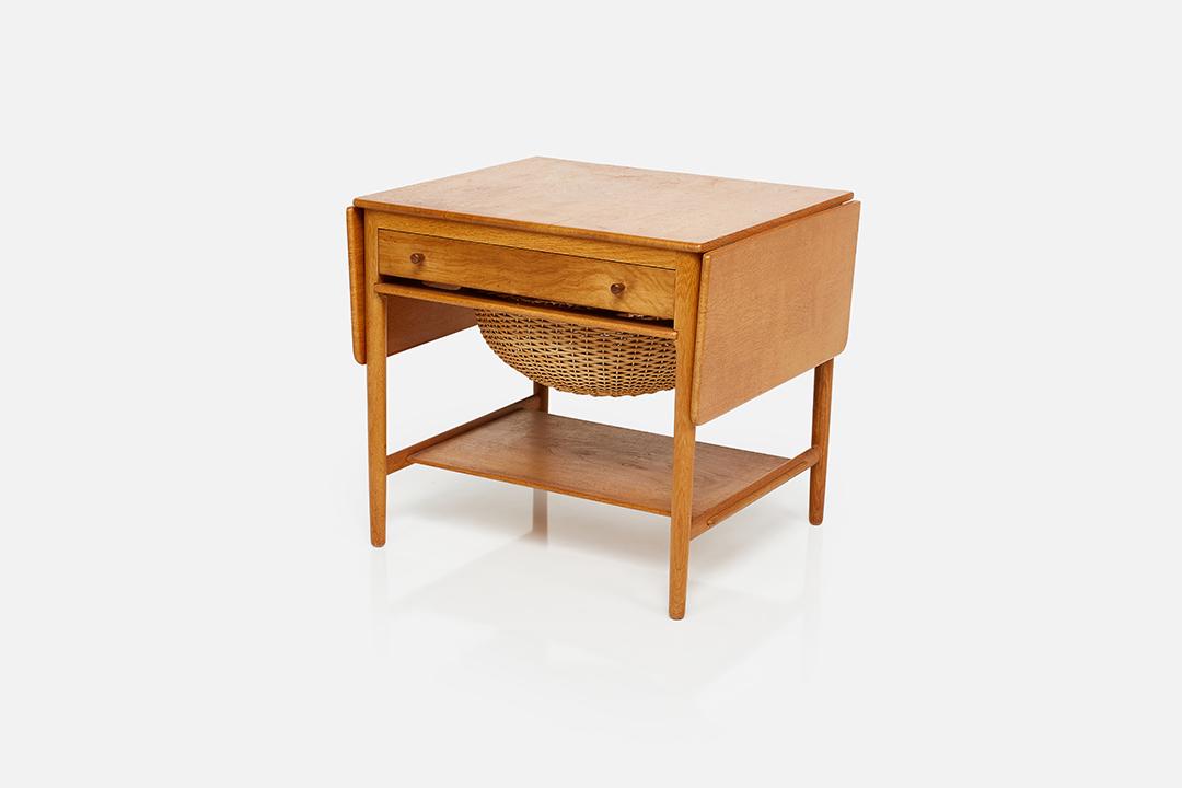 Hans J. Wegner, Sewing Table: Hans J. Wegner Sewing table, model no. AT-33, 1950s Oak, wicker, walnut. Produced by Andreas Tuck, Denmark. Underside with producer's brand. 23.75" H x 26.25" W x 22.75" D Fully extended: 46.5" W