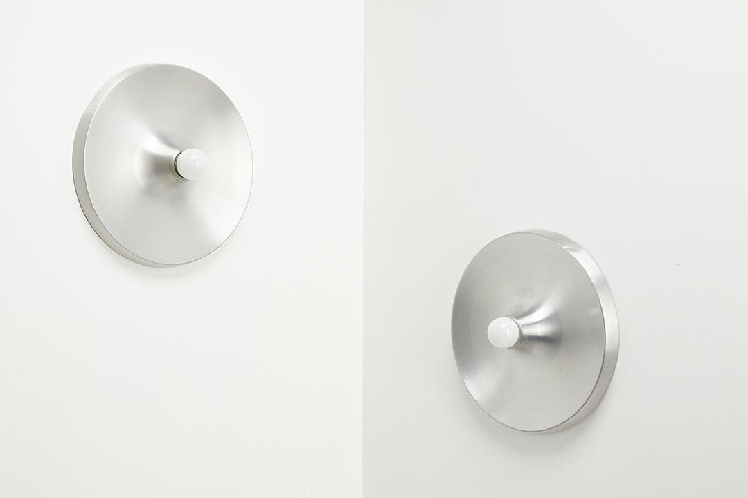 Charlotte Perriand, Sconces (2): Charlotte Perriand Pair of sconces from Les Arcs, ca. 1968 Aluminum. Manufactured by Honsel, Germany. Each: 12" Diameter, 2.5" Deep Provenance: Les Arcs 1600 Ski Resort, France