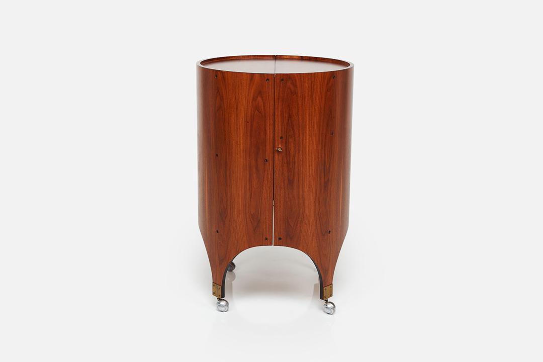 Henry P. Glass, Rolling Bar Cabinet: Henry P. Glass Cylindra' rolling bar cabinet, ca. 1966 Walnut-veneered plywood, stainless steel. Manufactured by Richbilt Manufacturing Company, USA. 36.5" H x 24" W x 23.5" D 40" wide when fully open