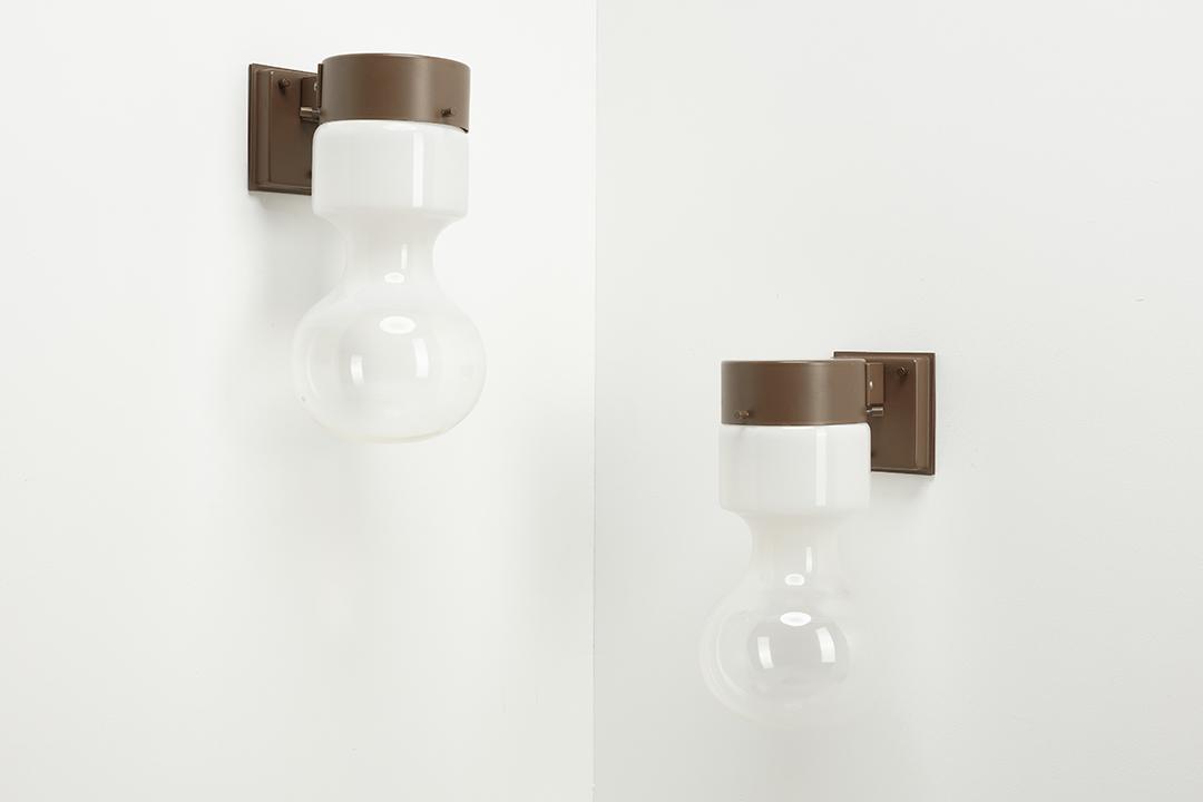 Raak, 'Hourglass' Sconces (2): Raak Pair of 'Hourglass' sconces, model no. W-1828, ca. 1972 Partially-frosted glass, painted metal. Manufactured by Raak, The Netherlands. Base interiors with manufacturer's sticker. Each: 14" H x 7"
