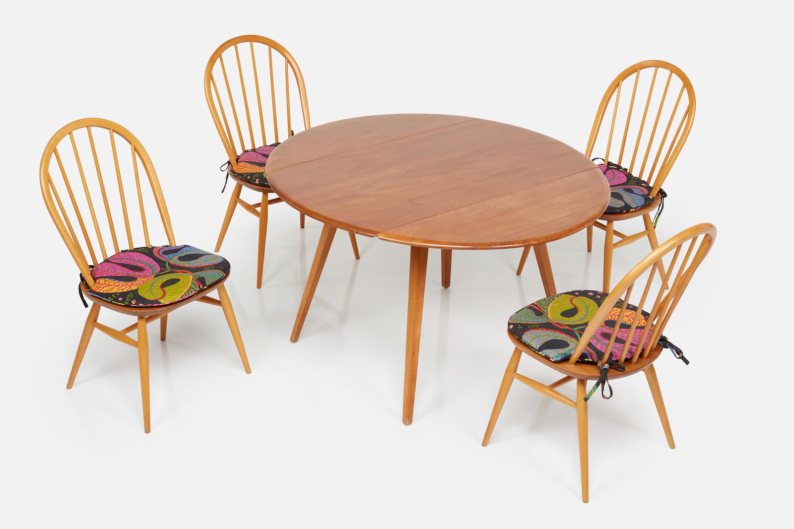 Lucian Ercolani, Dining Set (5): LUCIAN ERCOLANIDrop-leaf dining table, model no. 384 and set of four dining chairs, 1960sElm, beeh, Josef Frank for Svenskt Tenn fabric. Manufactured by Ercol, UK.Each with manufacturer's label.Ta