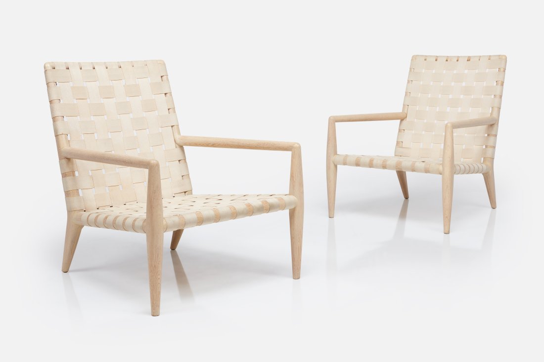 T. H. Robsjohn-Gibbings, Lounge Chairs (2): T. H. ROBSJOHN-GIBBINGS Pair of lounge chairs, model no. 1720, 1950s Bleached walnut, canvas webbing, cowhide. Manufactured by Widdicomb, USA / UK. Seat of one with manufacturer's label. Each: 31" H x