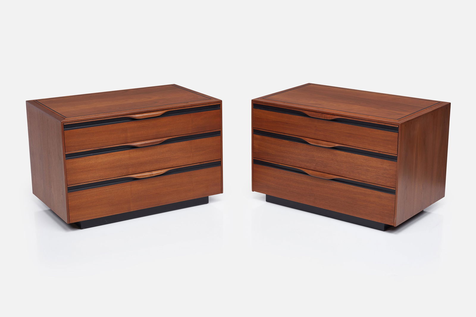 John Kapel, Three-Drawer Dressers (2): JOHN KAPELPair of three-drawer dressers, 1960sWalnut, plastic. Manufactured by Glenn of California, USA.Drawer interior with manufacturer's roundel. Each: 22" H x 34" W x 21.5