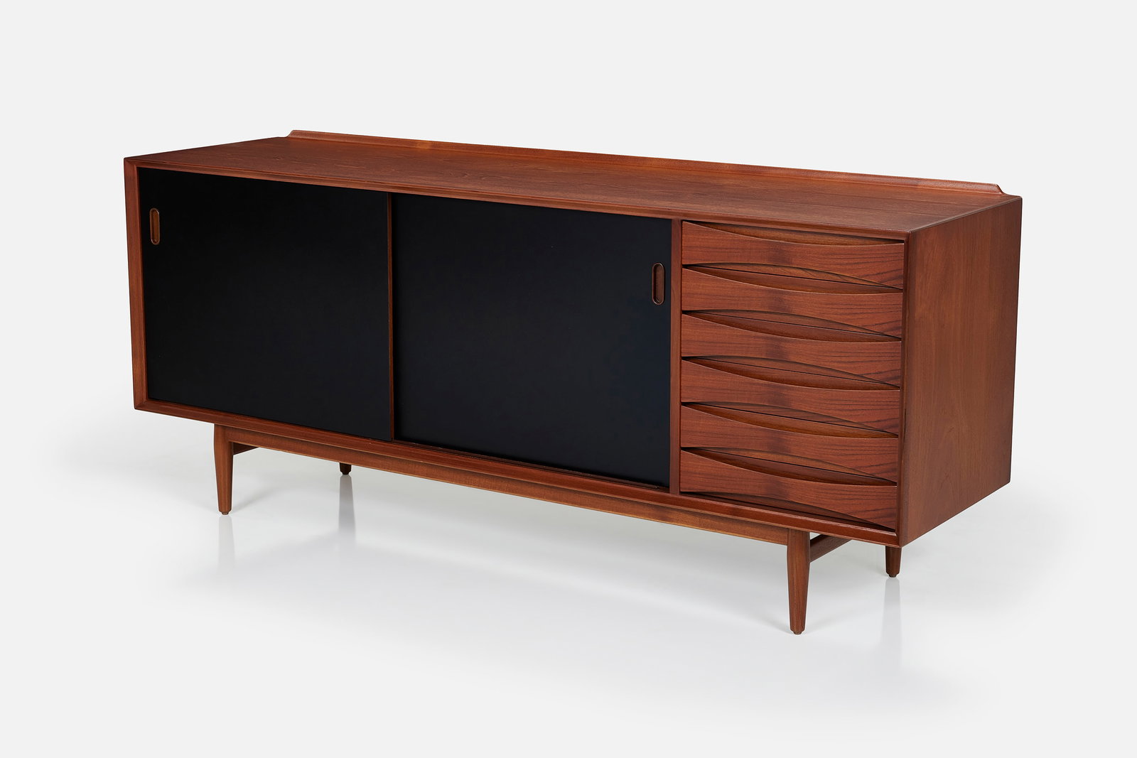 Arne Vodder, Reversible-Door Credenza: ARNE VODDERReversible-door credenza, 1960sTeak, lacquered wood. Manufactured by Sibast Mobler, Denmark. 31" H x 72" W x 19.5" D
